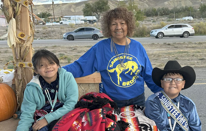 Teacher and two young students are celebrating the 112th Northern Navajo Fair