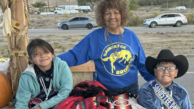 Teacher and two young students are celebrating the 112th Northern Navajo Fair